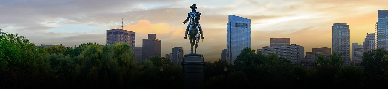 Photograph of George Washington Statue with Boston skyline in the background