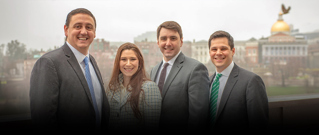 Group photo of Koufman Law Group, LLC with the Massachusetts State House in the background